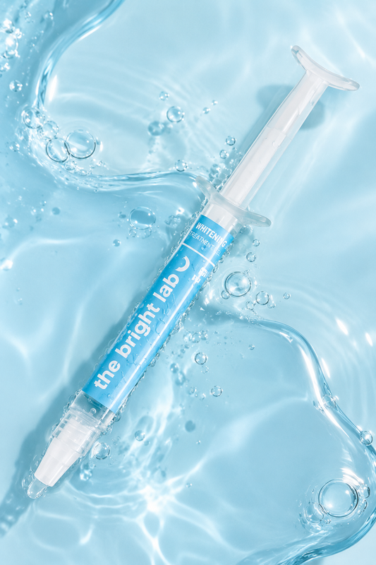 The Bright Lab whitening treatment gel syringe resting in clear water