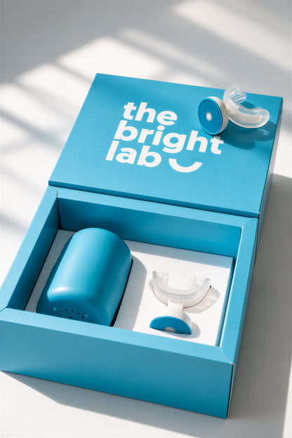 The Bright Lab presentation box opened, showing the teal case and LED mouthpiece in the tray