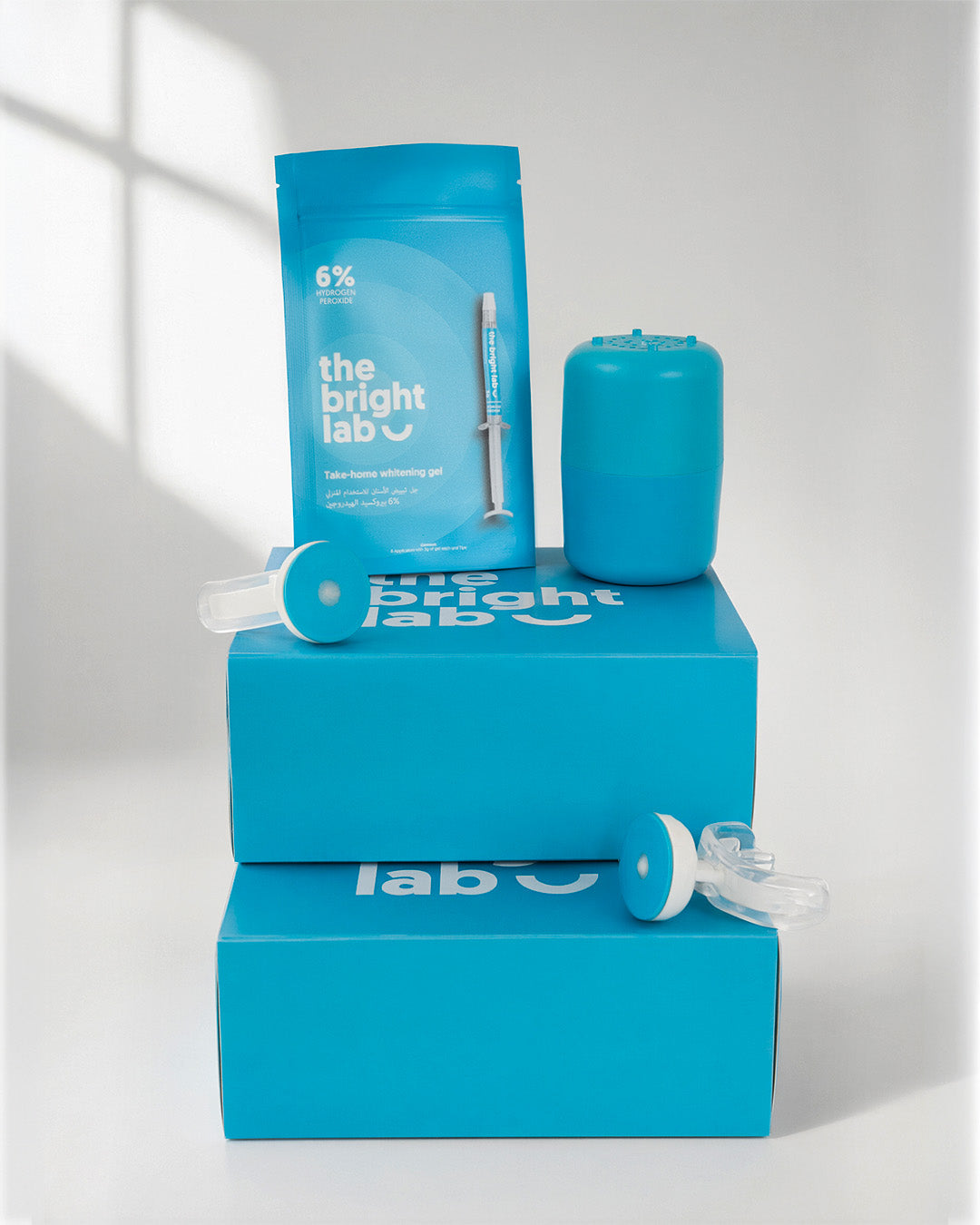 The Bright Lab Whitening System with the gel sachet, case and mouthpiece arranged on the retail boxes